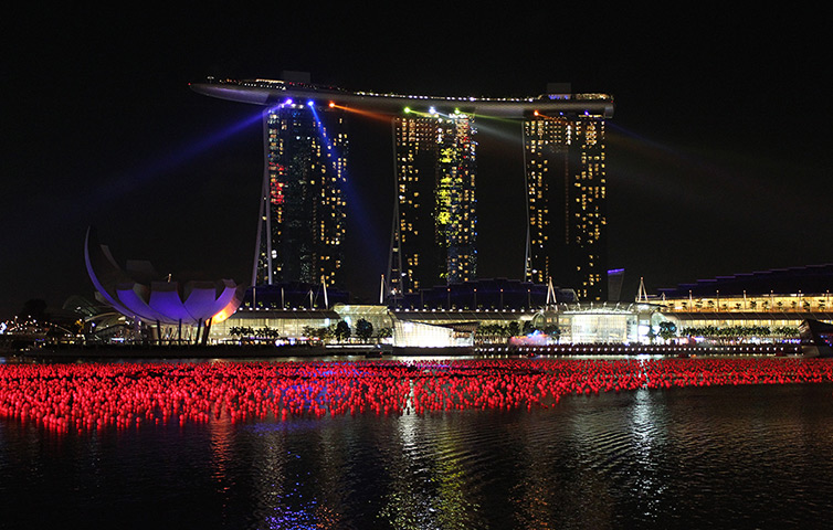 New year preparations: Singapore:  Marina Bay Sands is lit up by a light display during rehearsals