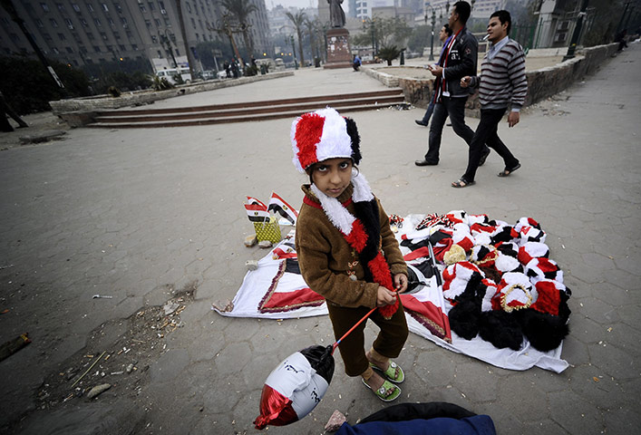 24 hours in pictures: Egyptian youth sells hats in the national colours