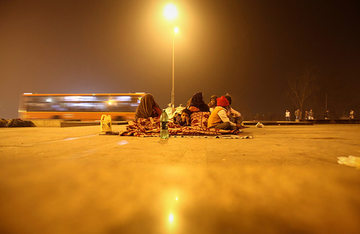 24 hours in pictures: An Indian family under a flyover near a bus terminus in New Delhi, India
