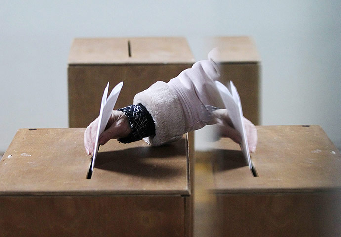 russia elections: A woman casts her ballot at a polling station in Moscow