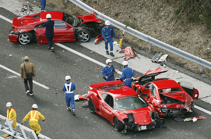 Japan car pile-up: Police officers investigate wrecked luxury cars