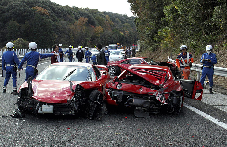 Japan car pile-up: Police officers inspect the cars on the Chugoku highway