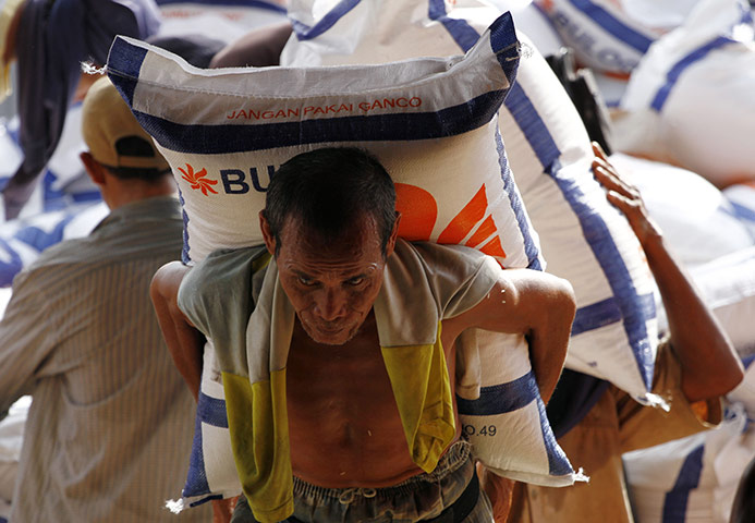 24 hours in pictures: Jakarta, Indonesia: Workers unload rice from a truck at a state warehouse 