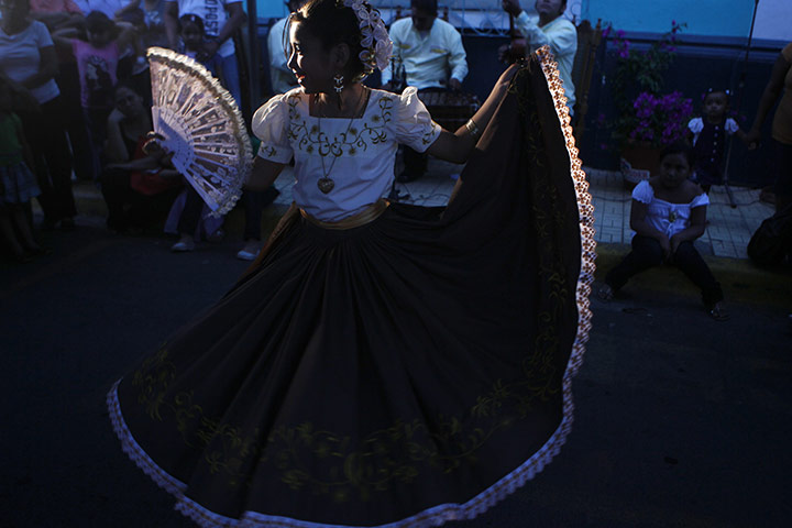 24 hours in pictures: Masaya, Nicaragua: A girl takes part in a dance festival for Saint Jerome