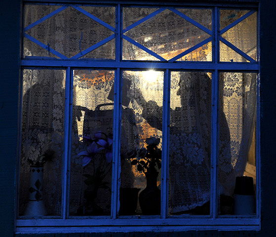 24 hours in pictures: Shestaki, Russia: A woman casts her ballot in a mobile ballot box