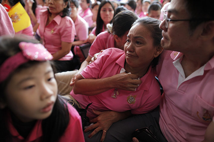 24 hours in pictures: Bangkok, Thailand: People react after seeing Thailand's King 