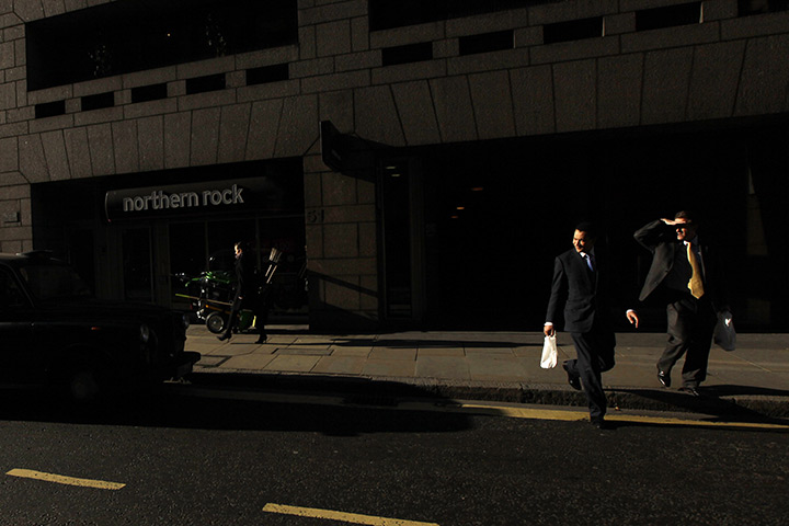 from the agencies: A city worker in front of a branch of Northern Rock
