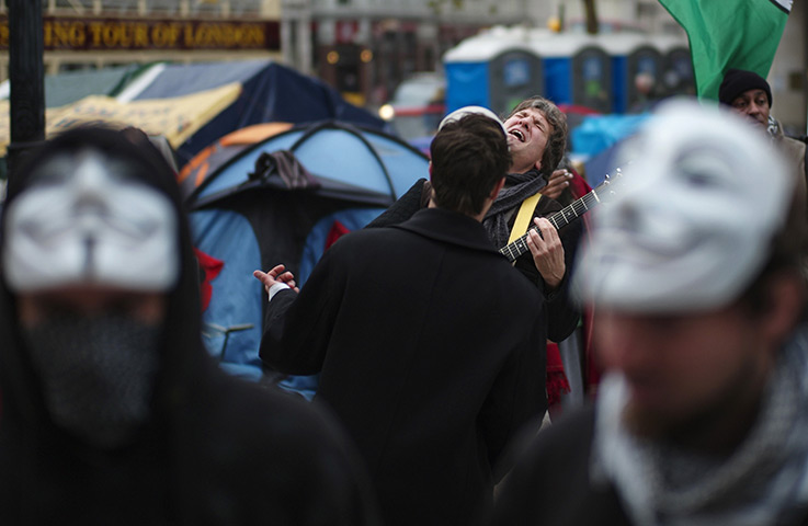 from the agencies: An Occupy London plays his guitar outside St Paul's Cathedral 