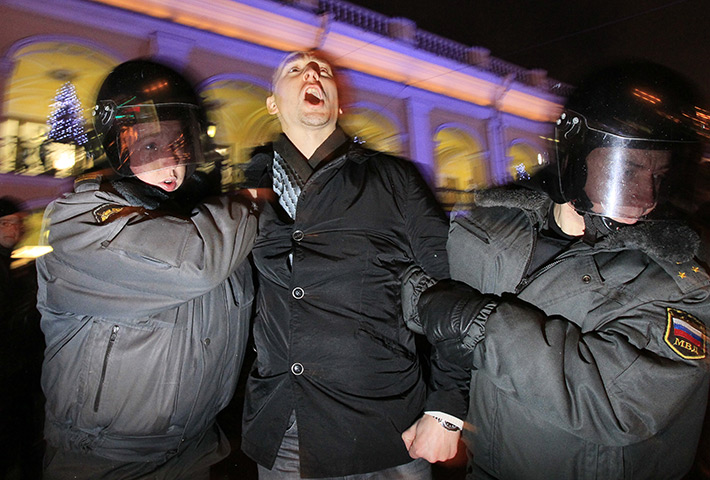Russia protests: Police detain an activist at protest against vote rigging in St Petersburg