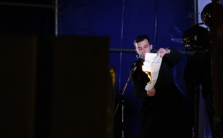 Russia protests: Opposition member Roman Dobrokhotov burns his ballot at a rally in Moscow