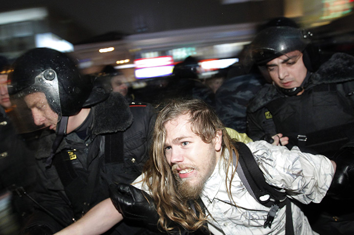 Russia protests: Russian police detain a participant during an opposition protest in Moscow