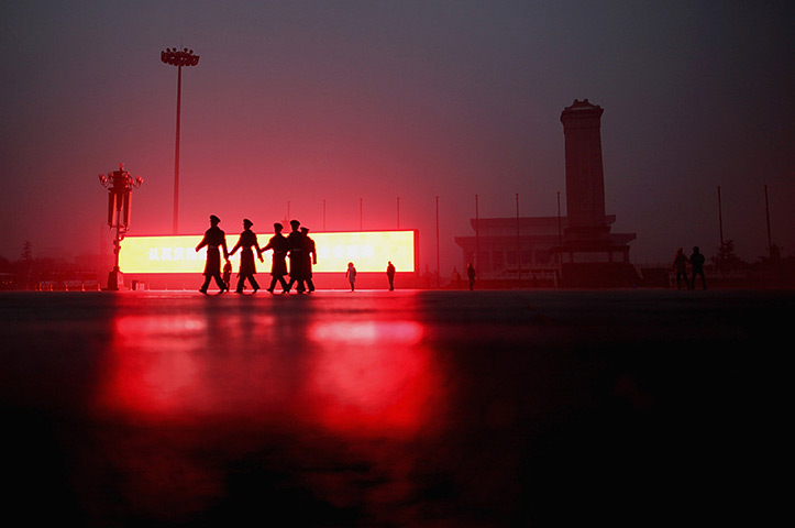 24 hours in pictures: Beijing, China: Paramilitary policemen on Tiananmen Square
