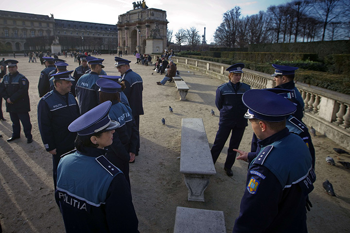 24 hours in pictures: Paris, France: Romanian police officers