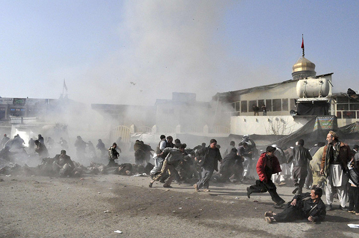 24 hours in pictures: Kabul, Afghanistan: People react seconds after a suicide blast