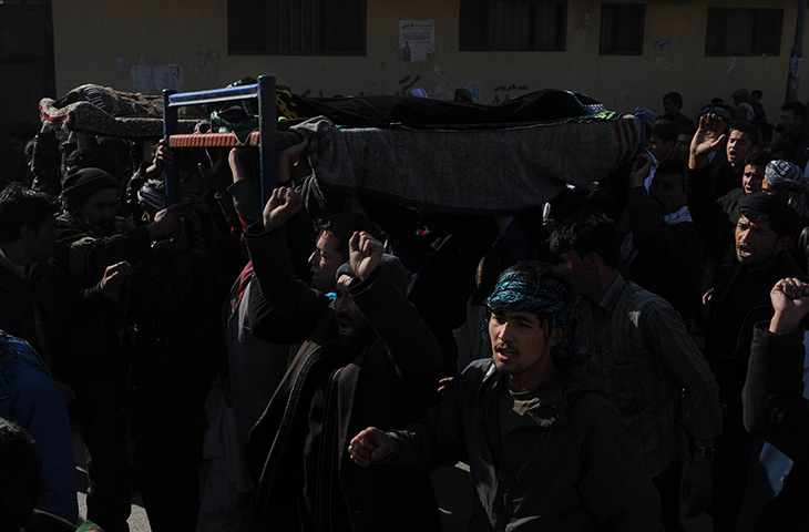 24 hours in pictures: coffins of victims of a bomb attack against Shiite Muslims in KAbul 