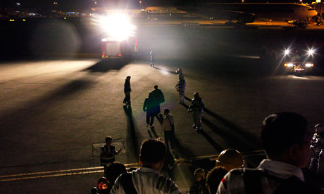 Passengers disembark from jet