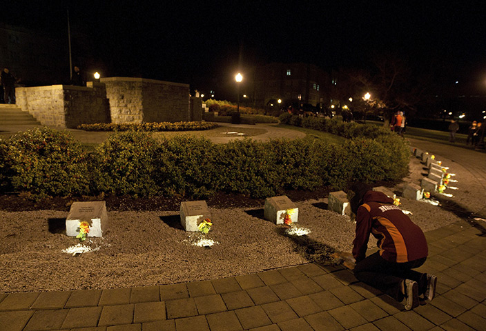 Virginia Tech shooting: A Virginia Tech student places flowers at Virginia tech memorial site