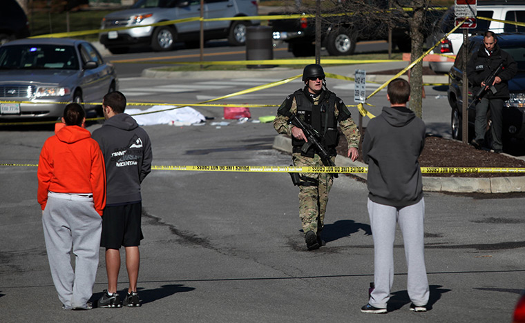 Virginia Tech shooting: A police officer secures the scene where a gunman killed a police