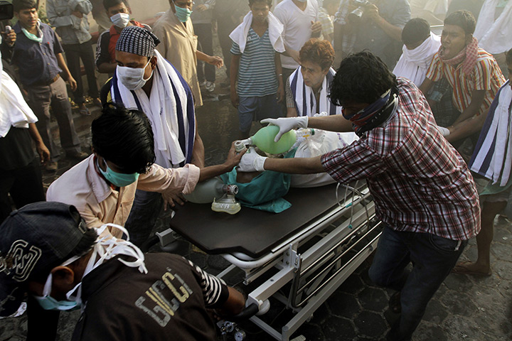 24 hours in pictures: Kolkata, India: People help carry a patient out of a nursing