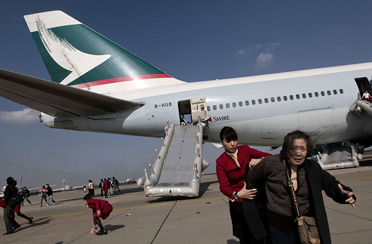 24 hours in pictures: Shanghai, China: Passengers are evacuated from an aircraft