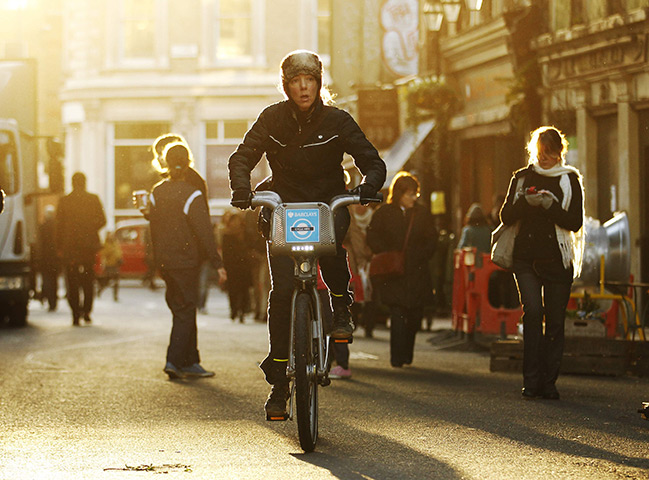 24 hours in pictures: London, UK: A woman cycles through Borough Market