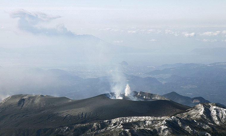 Shinmoedake volcano Japan: White smoke rises from the crater on Mount Shinmoedake, Japan