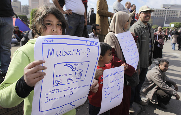 Egypt placards: A girl holds a poster during a demonstration in Cairo