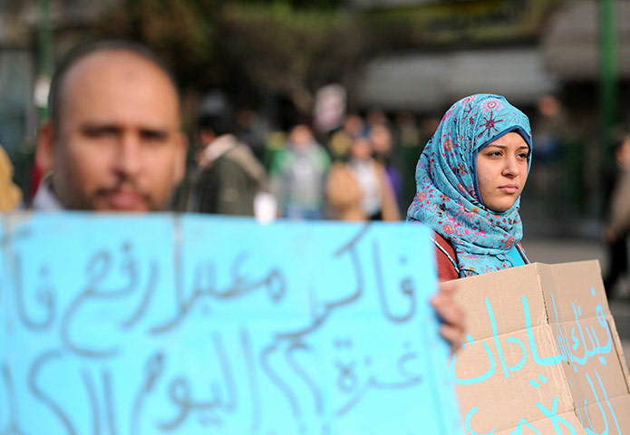 Egypt protests: An Egyptian man and woman hold up signs 