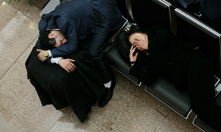 24 hours in pictures: A man and woman attempt to sleep at Cairo International Airport