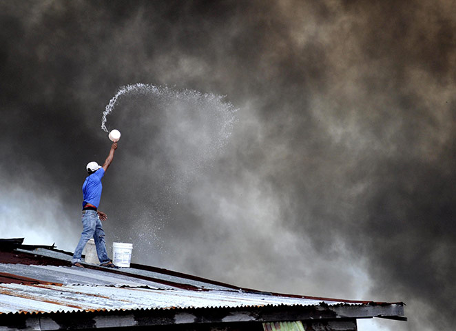 24 hours in pictures: Water lodge fires, Tawau, Sabah, Malaysia - 31 Jan 2011