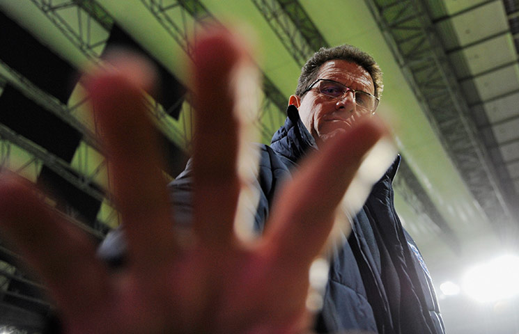 Denmark v England: Fabio Capello gets camera shy before kick-off