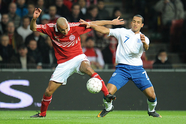 Denmark v England: Theo Walcott and Simon Poulsen tussle for the ball