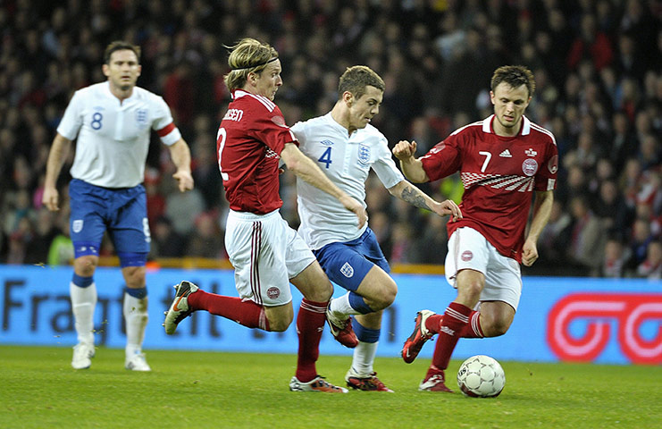 Denmark v England: Jack Wilshere bursts between Christian Poulsen and William Kvist Jorgensen 