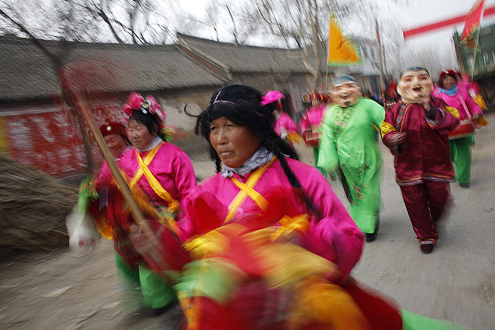 from the agencies: Locals wearing traditional costumes take part in the wedding procession