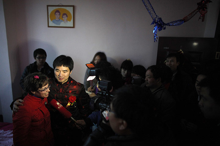 from the agencies: A local television crew interviews Rebecca and Liu after their  wedding