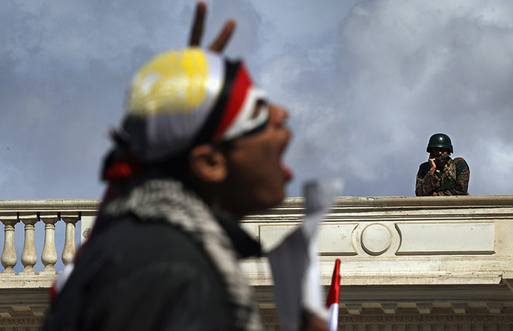 Egypt day 17: An anti-government protester chants as an Egyptian army soldier watches