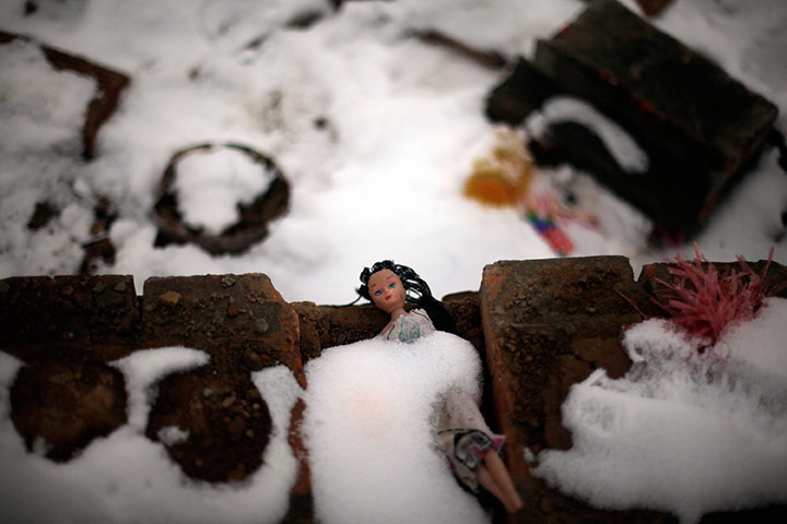 24 hours in pictures: An abandoned doll is covered by snow near Xianghe city, China