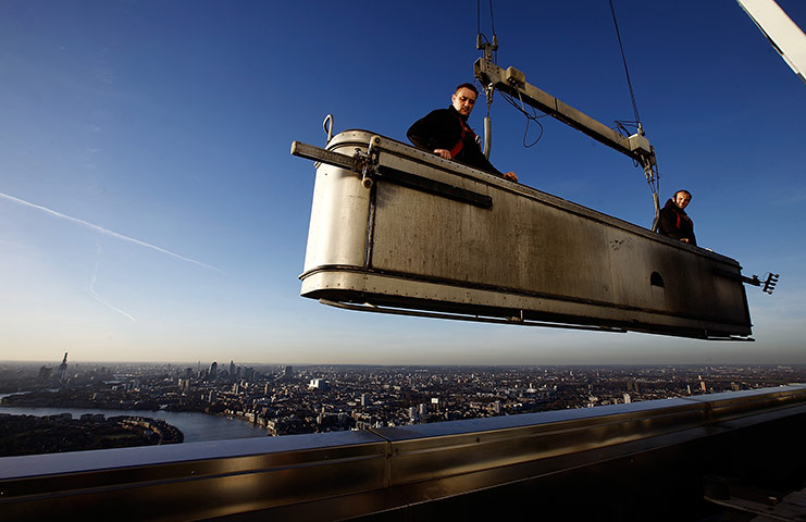 24 hours in pictures: Window cleaners above One Canada Square skyscraper, London