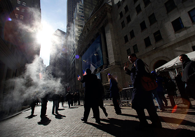 24 hours in pictures: People walk in front of the New York Stock Exchange