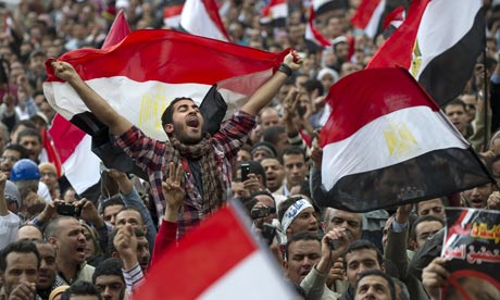 Protesters wave flags in Tahrir Square