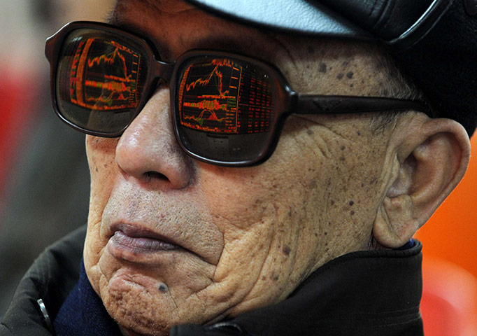 Week in Business: Electronic board showing stock information is reflected in Taiyuan, China