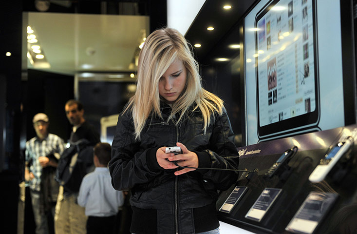 Week in Business: A customer tests Nokia's new mobile phone in the flagship store, Helsinki