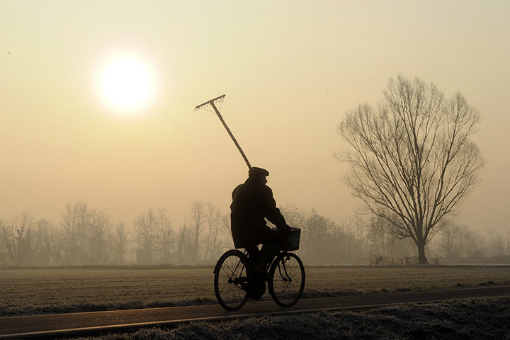 24 hours in pictures: A man rides a bike in the Italian countryside 
