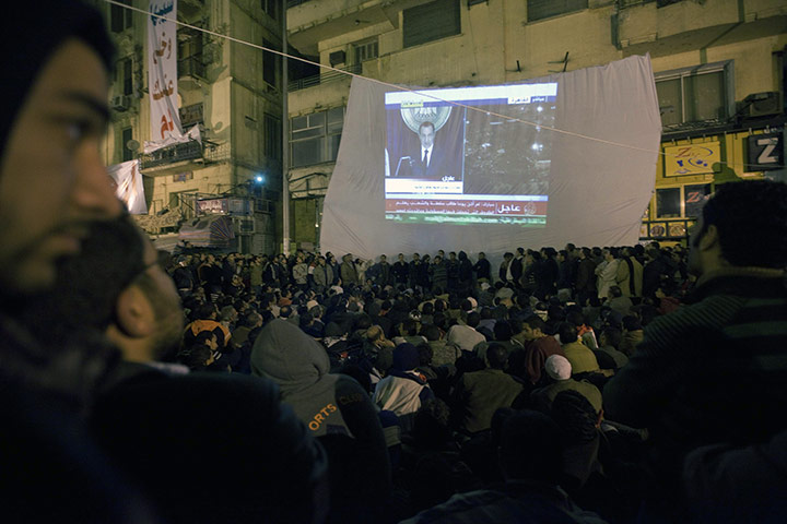 mubarak life and times: Protestors in Tahrir Square watch President Mubarak's televised speech 