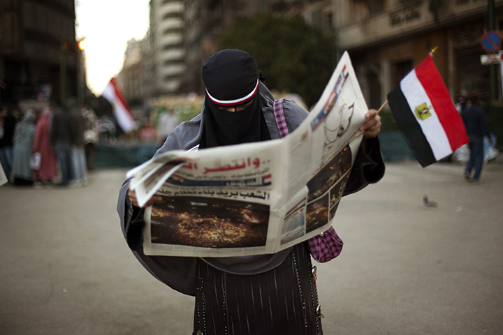 Egypt Day 19: An Egyptian woman reads the newspaper in Tahrir Square