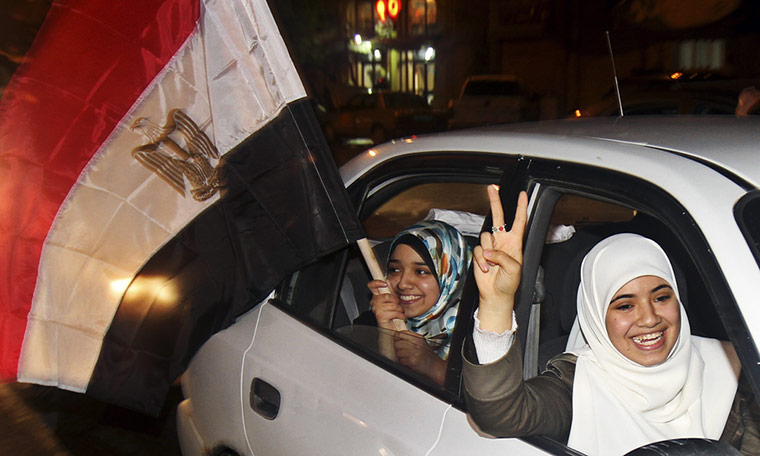 Egypt reaction: Palestinian women wave an Egyptian flag