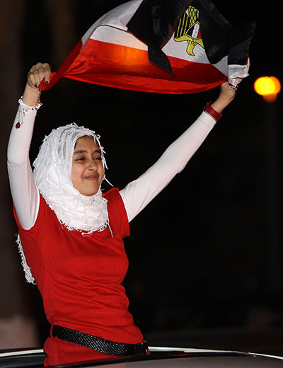 Egypt reaction: A youth waves an Egyptian flag