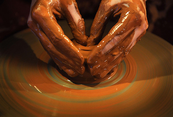 24 hours in pictures: A woman makes a pot during a ceramics lesson