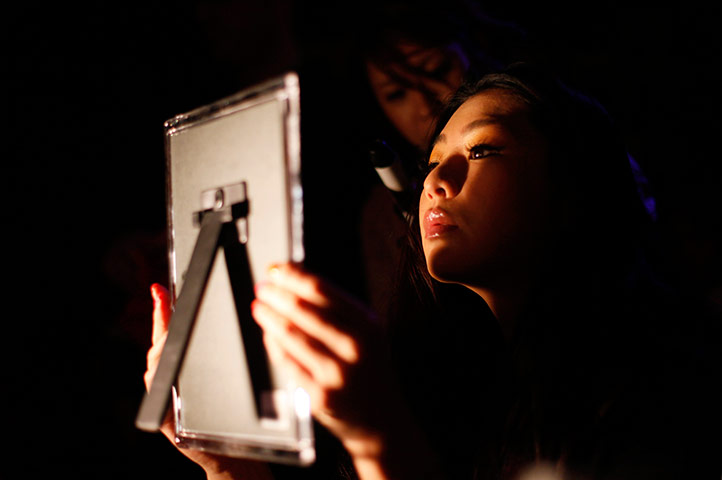 24 hours in pictures: Model prepares her make-up before Tokyo Fashion Fuse
