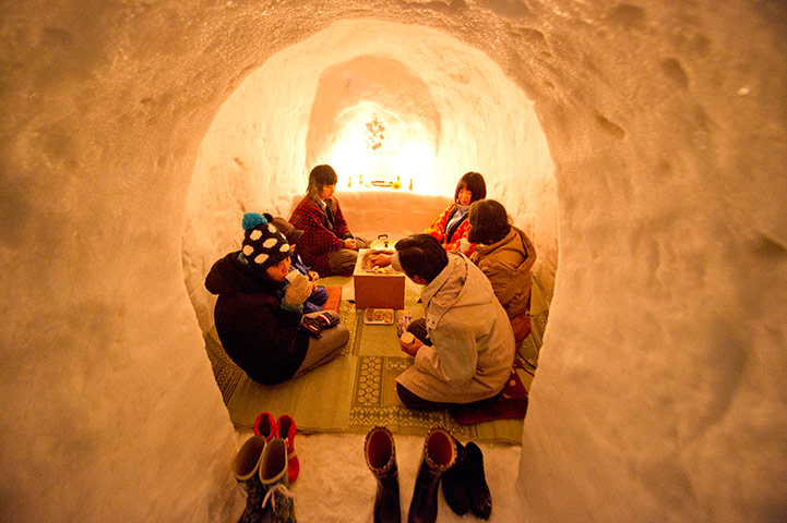 24 hours in pictures: Family enjoying a meal inside a small igloo, Japan
